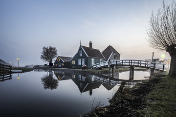 Beaucoutif typical Dutch wooden houses architecture mirrored on the calm canal of Zaanse Schans located at the North of Amsterdam, Netherlands