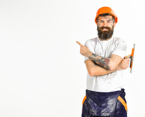 Man with smile holds putty knife or tool
