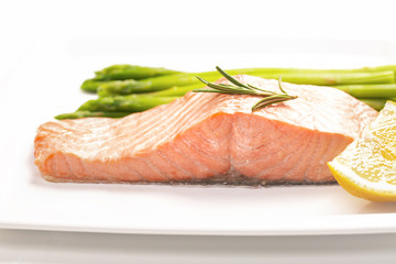 Steamed salmon and asparagus on a white plate