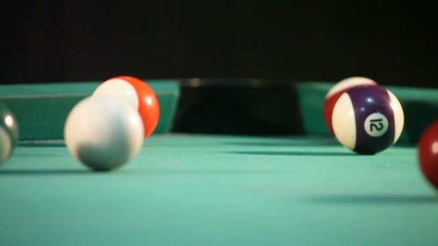 Billiard ball  falling into the hole among other  balls
