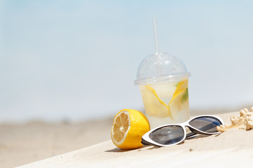 Flip flops, sunglasses and accessiores on sandy beach. holidays background. Copy space.