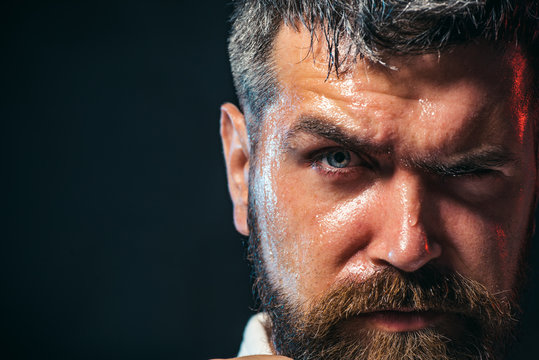 Portrait of boxer before fight, closeup. Partial view of a karate man in kimono. Portrait of handsome aikido fighter. Copy space.