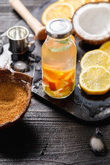 Cocktails ingredients with coconut sugar in coconut shell, Metal ice bucket, old scissors on marble board on black rustic table, Mojito, alcoholic, non-alcoholic drink-beverage. Top view, copy space