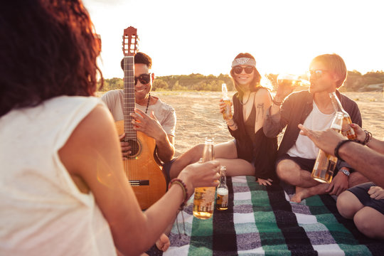 Young group of friends outdoors on the beach