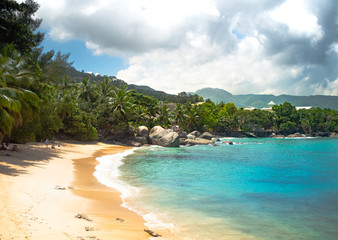 Fototapeta na wymiar Seychelles Beach with clouds and clear water