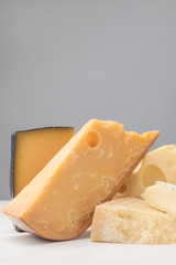 Close up shot of different types of cheese on gray