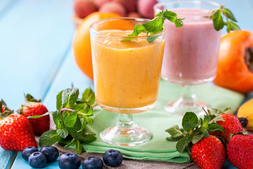 Orange persimmon blueberry smoothie   and fruits. Selective focus. Copy space. Top view