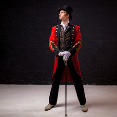 Showman. Young male entertainer, presenter or actor on stage. The guy in the red camisole and the...