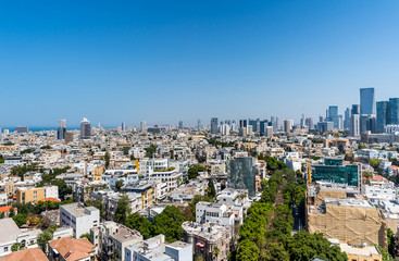 Fototapeta na wymiar Rooftop view of boulevard Rothschild in Tel Aviv. Old houses and modern skyscrapers.