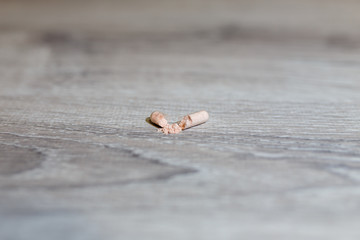 Opened capsules, carnitine, creatine, fat burners, BCAA or testosterone booster. Sports medical vitamins and preparations on a wooden table. Medicinal preparation in the form of powder in capsules.