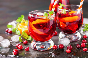 Summer drink Sangria with orange and cranberry. Selective focus. Copy space