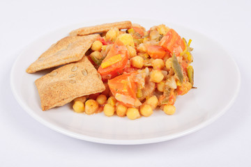 Baked vegetables and cheese biscuits on a white