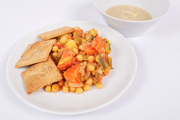 Baked vegetables and cheese biscuits on a white