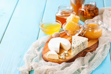 Cheese and honey on a table. Selective focus. Copy space