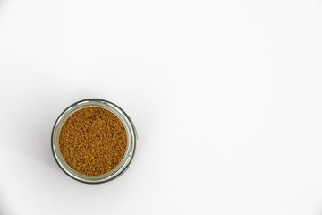 Rose hip powder in a glass jar. Copy space for text on white background.