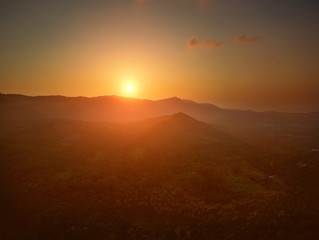 Aerial view of sunset over mountain jungle
