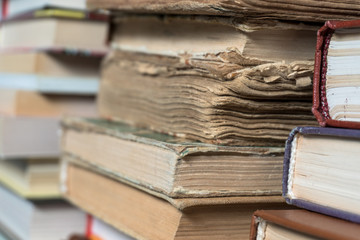 Many books in a bookstore or library on wooden background with copy space