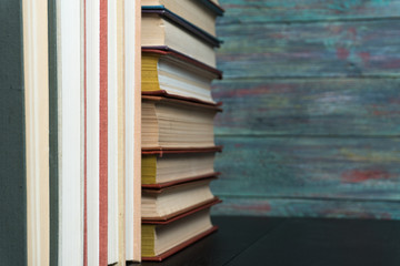 Stack books on wooden background. Back to school with copy space.
