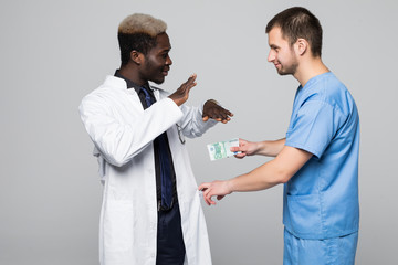 Medical doctor refuse bribing money from surgeon isolated on gray background