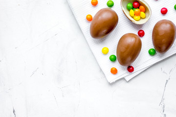 Easter chocolate eggs top view on stone background mock up