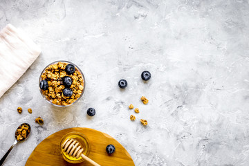 Oat flakes and berries granola glass on table background top vie