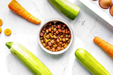 Vegetables and petfood on kitchen table background top view