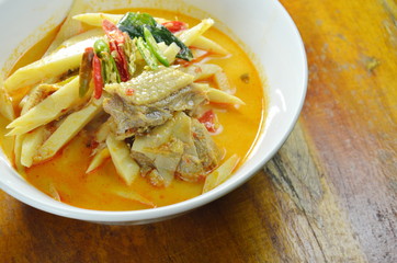 spicy boiled chicken with bamboo shoot in coconut milk curry on bowl