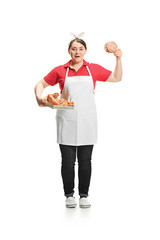 Portrait of cute smiling woman with pastries in her hands in the studio, isolated on white background