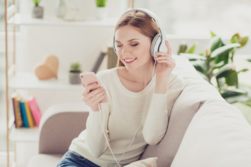 Naklejka premium Track tune audio book cool teenager people person play peace purity dj freetime concept. Cute lovely beautiful sweet attractive careless girl toothy smile dressed in white sweater listening to music