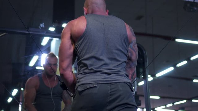 man trining chest in crossover machine