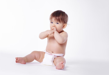 Naked baby sitting on floor