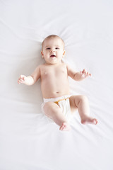 Naked baby lying on back at studio shot © gpointstudio