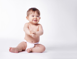 Baby sitting with diaper at studio shot