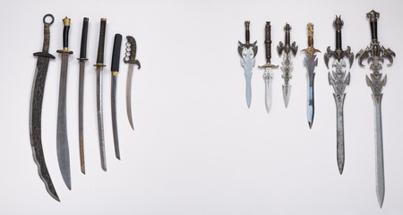 collection of medieval swords, knives and daggers