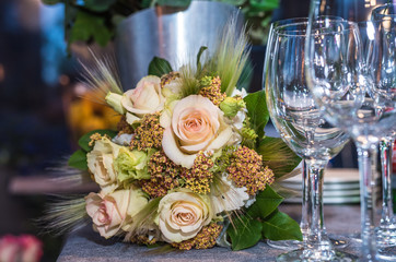Beautiful flowers on the table with empty wine glasses