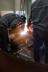 worker with protective mask welding metal