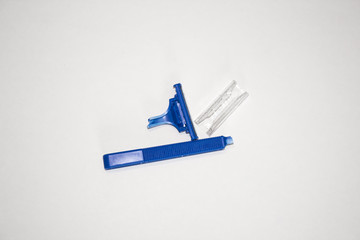 broken single-use blue manual shaving machine on white background