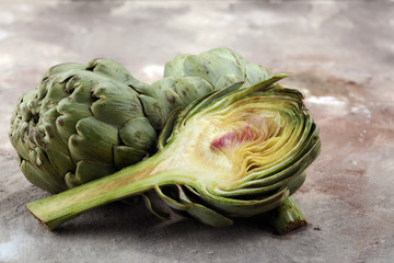 Obraz premium artichokes on grey background. fresh organic artichoke flower.