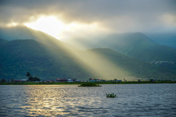 Naklejka na ściany i meble Crepuscular Rays. Sun Shining Through Clouds at Inle Lake in Myanmar (Burma)
