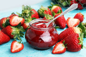strawberry jam with fresh strawberries. marmalade on spoon and jar