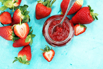 strawberry jam with fresh strawberries. marmalade on spoon and jar
