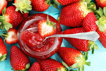 strawberry jam with fresh strawberries. marmalade on spoon and jar