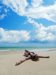 woman sunbathing lying down on the tropical beach