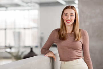 business, people and corporate concept - happy smiling businesswoman at office