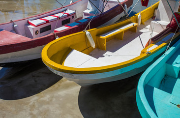 Fototapeta na wymiar Colorful wooden fishing boats on a sunny day in a lake