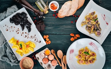 Set of Ukrainian cuisine. Vareniks, fresh vegetables, spices. Top view. On a wooden background. Copy space.