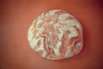 Traditional round rye bread on wooden background