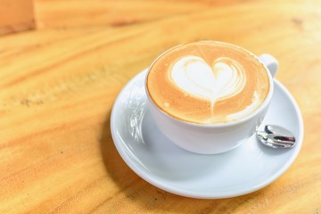 Top View of Cup of Coffee with Latte Art Heart Isolated on Wooden Table