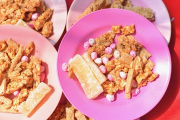 Piles of Traditional Chinese Snacks Consisting of Peanuts and Sesame Candy Bars