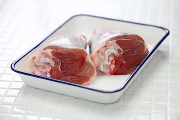raw lamb shank isolated on white butcher tray